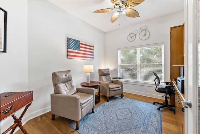 sitting room with light wood-type flooring and ceiling fan