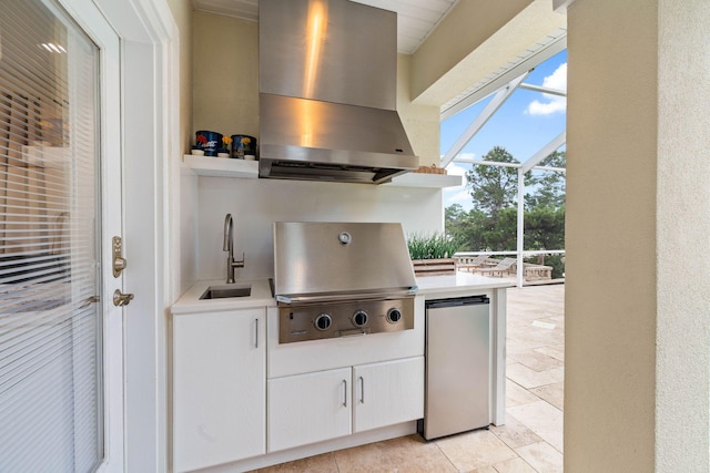 view of patio featuring sink, an outdoor kitchen, glass enclosure, and a grill