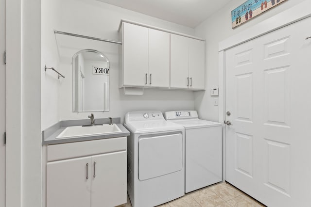 washroom featuring cabinets, light tile patterned floors, separate washer and dryer, and sink