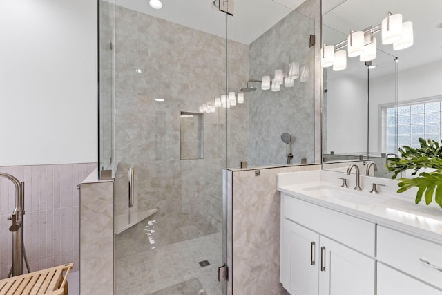 bathroom featuring vanity, an enclosed shower, and tile walls