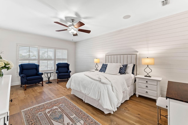 bedroom with ceiling fan and light hardwood / wood-style flooring