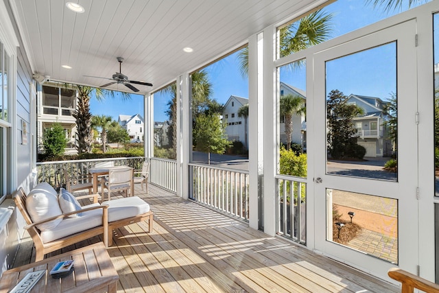 sunroom / solarium with ceiling fan and wood ceiling