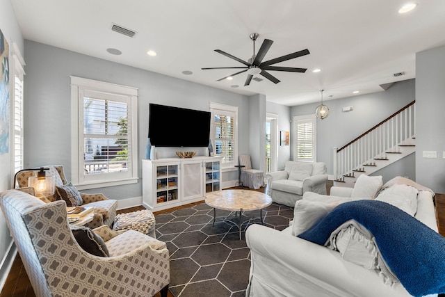 living room featuring dark hardwood / wood-style flooring and ceiling fan