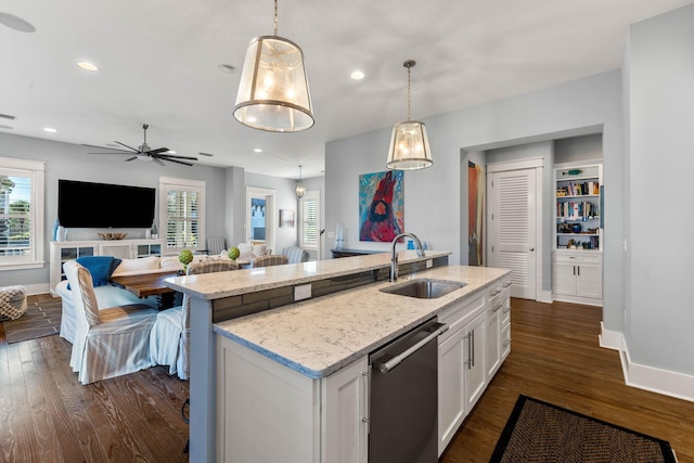 kitchen with dishwasher, white cabinets, decorative light fixtures, and sink