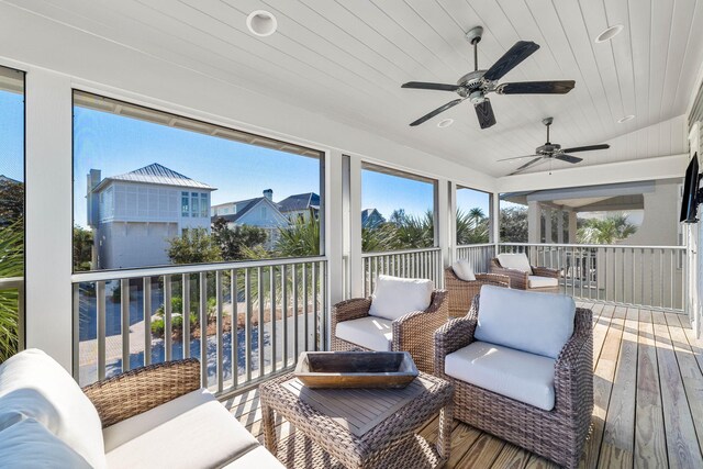 sunroom featuring ceiling fan, wood ceiling, and lofted ceiling