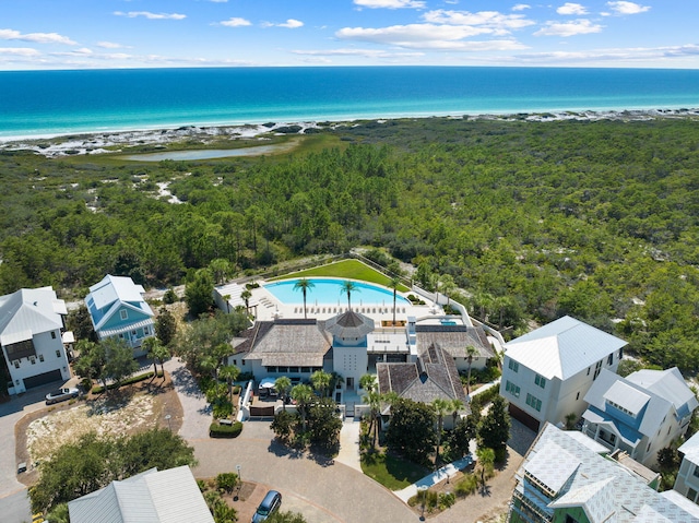 birds eye view of property featuring a water view and a beach view