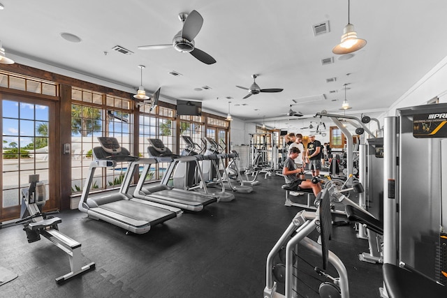 gym with ceiling fan and ornamental molding