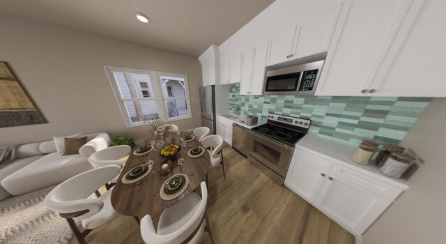 kitchen featuring white cabinetry, appliances with stainless steel finishes, and decorative backsplash