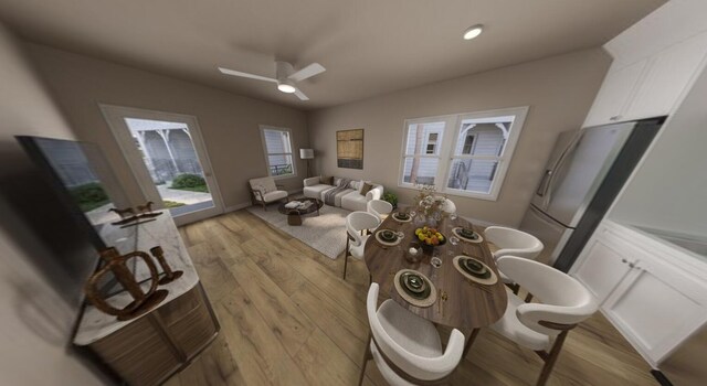 living room featuring vaulted ceiling, ceiling fan, and light hardwood / wood-style flooring