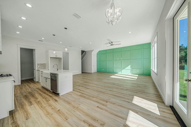 kitchen featuring white cabinets, pendant lighting, light hardwood / wood-style floors, and a kitchen island with sink