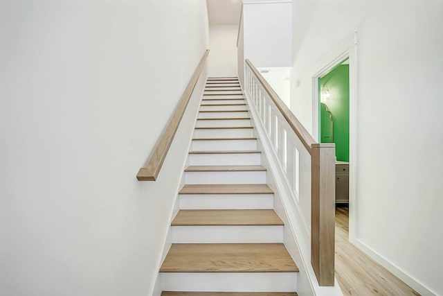 stairway featuring wood-type flooring