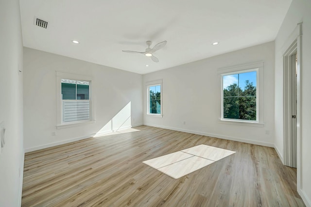 spare room featuring ceiling fan and light hardwood / wood-style flooring