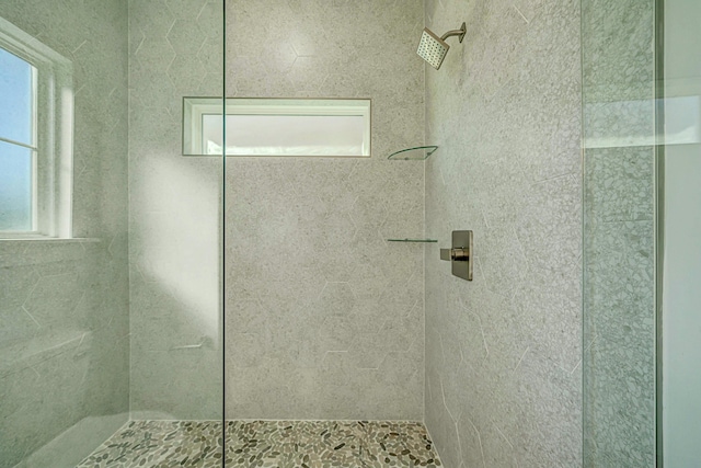 bathroom with a tile shower