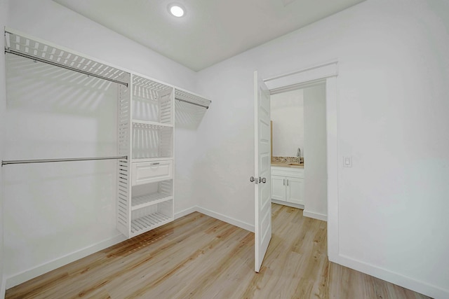 walk in closet featuring light hardwood / wood-style floors