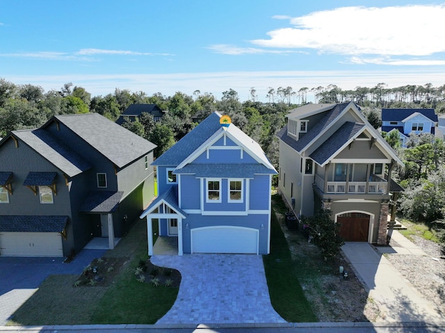 view of front facade featuring a balcony and a garage