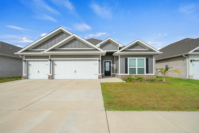 craftsman house with a front yard and a garage