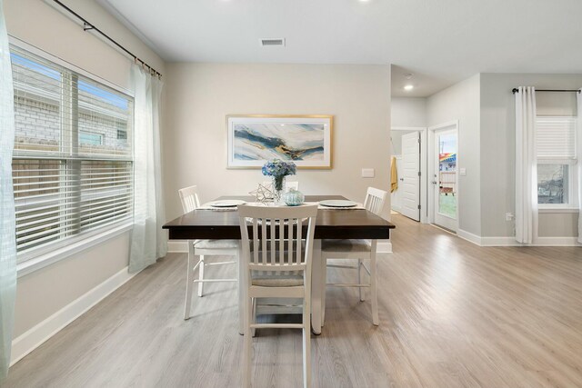 dining space featuring light hardwood / wood-style floors