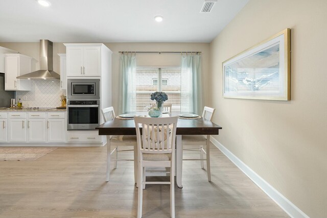 dining area with light wood-type flooring