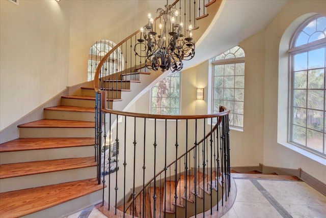 staircase featuring a notable chandelier