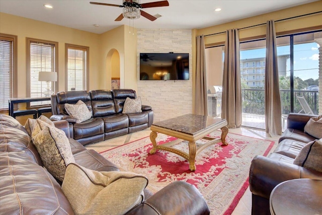 living room with ceiling fan and light tile patterned floors