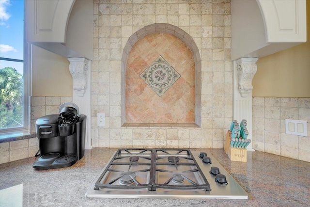 kitchen featuring white cabinetry, decorative backsplash, and stainless steel gas cooktop