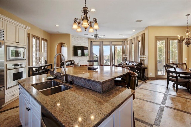 kitchen featuring a spacious island, a healthy amount of sunlight, and stainless steel appliances