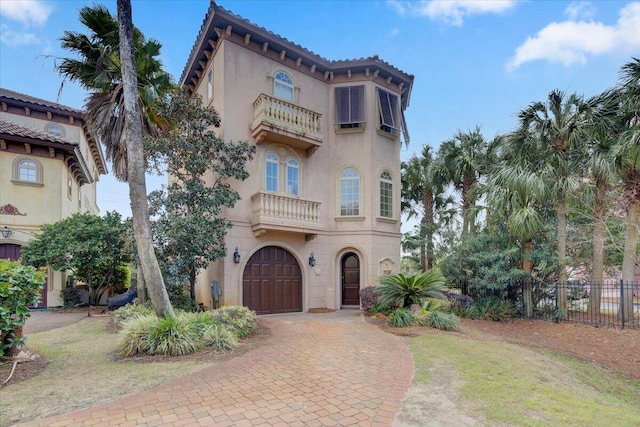 mediterranean / spanish home with a garage and a balcony