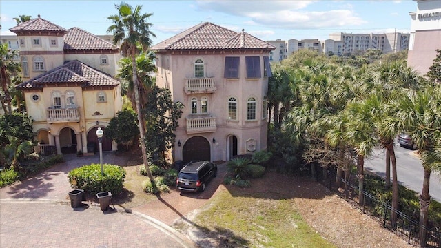 mediterranean / spanish house featuring a balcony