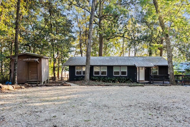 view of front of property with a storage shed