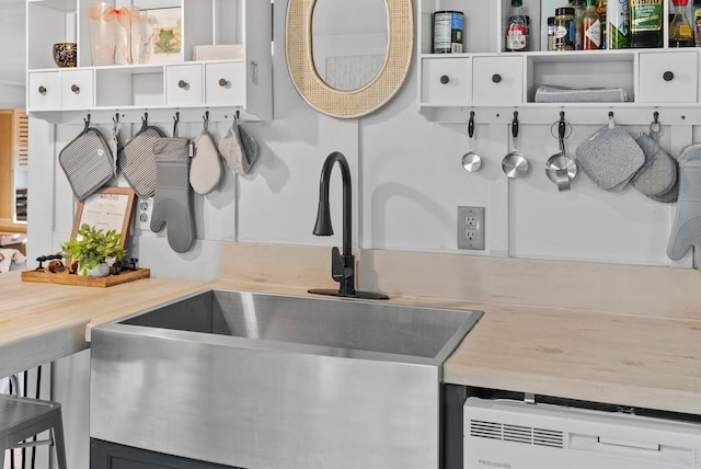 kitchen with white cabinets, dishwasher, and sink