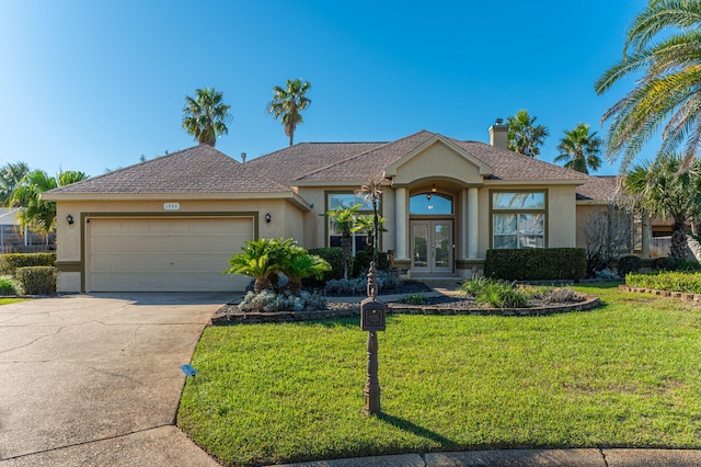 single story home featuring french doors, a front yard, and a garage