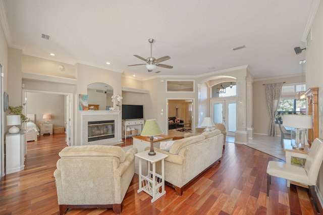 living room featuring ceiling fan, dark hardwood / wood-style flooring, french doors, and ornamental molding