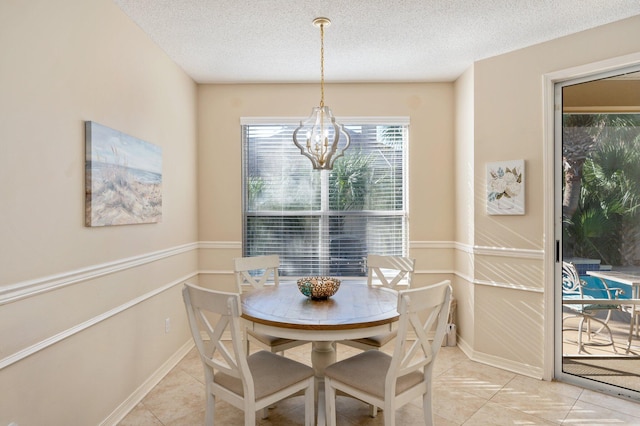 dining area featuring a textured ceiling, a notable chandelier, and light tile patterned flooring