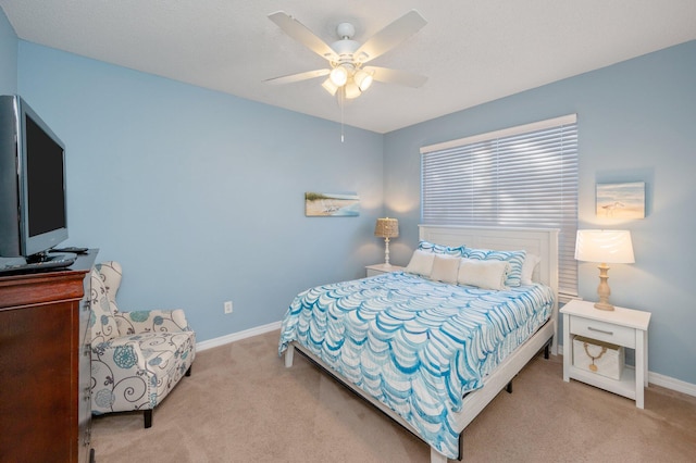 bedroom with ceiling fan and light colored carpet