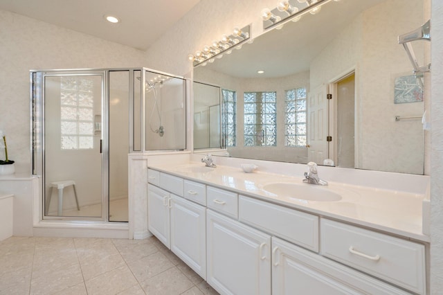 bathroom with tile patterned flooring, vanity, and a shower with shower door