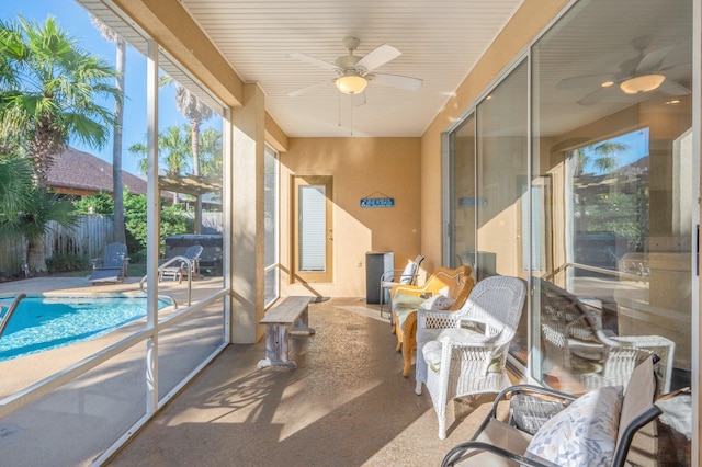 sunroom featuring ceiling fan