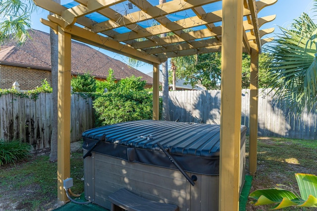 view of patio / terrace featuring a pergola and a hot tub