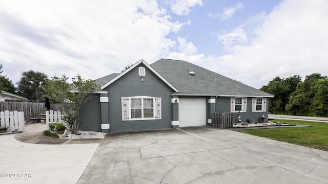 view of front of house featuring a garage and a front lawn