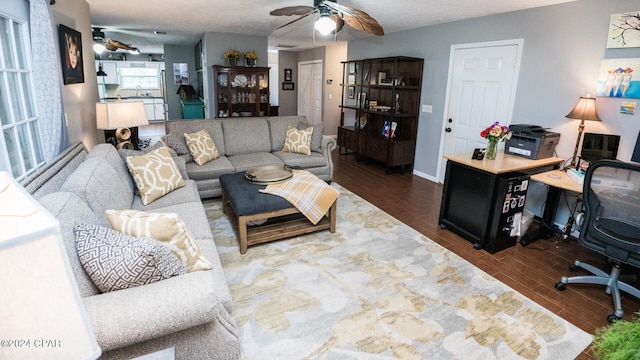 living room with dark hardwood / wood-style floors and ceiling fan