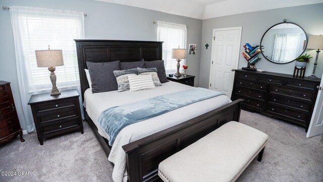 carpeted bedroom with vaulted ceiling