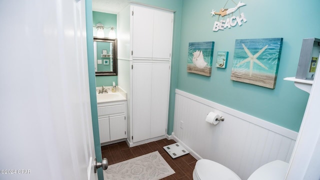 bathroom featuring vanity, wood-type flooring, and toilet