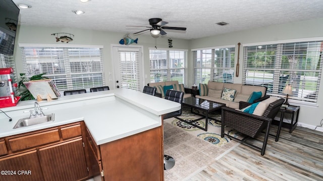 sunroom / solarium with ceiling fan and sink