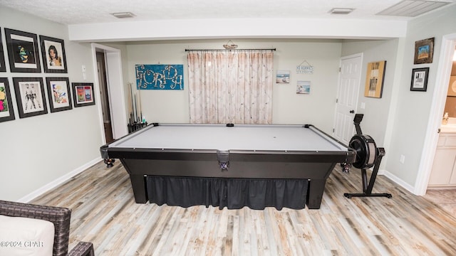 recreation room with a textured ceiling, pool table, and light hardwood / wood-style flooring