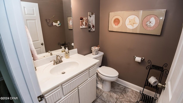 bathroom featuring tile patterned floors, vanity, and toilet