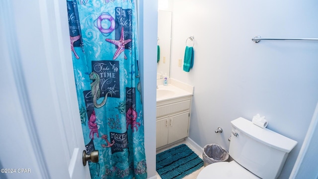 bathroom with vanity, toilet, and curtained shower