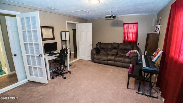 office area with carpet floors and a textured ceiling