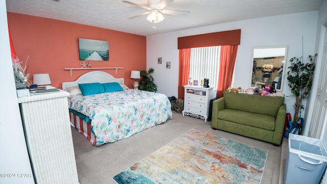 carpeted bedroom with a textured ceiling and ceiling fan