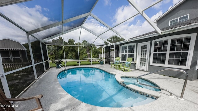 view of swimming pool featuring glass enclosure, an in ground hot tub, and a patio