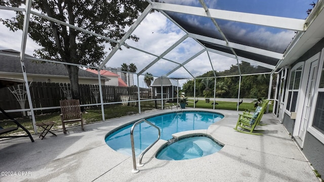 view of pool with a lanai, a patio area, and an in ground hot tub