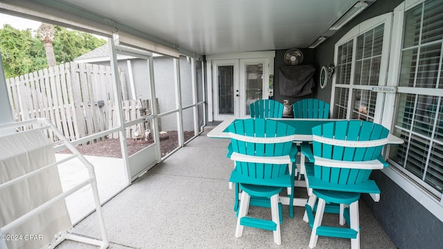 sunroom / solarium featuring french doors